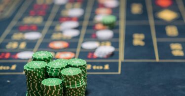 Stacks of green colored gambling chips