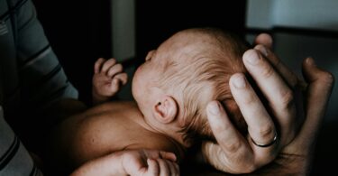 a man holding a baby in his arms